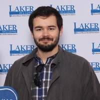 Alumnus holding foam finger